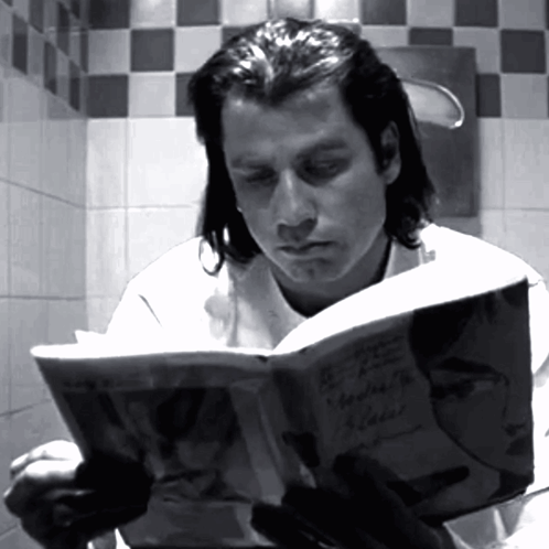 Man Reading Book in Bathroom