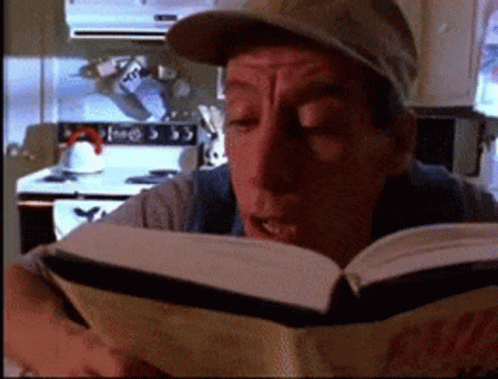 Man Reading Coca-Cola Book