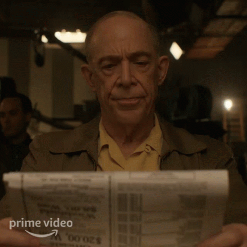 Man Reading Newspaper With Prime Video Logo