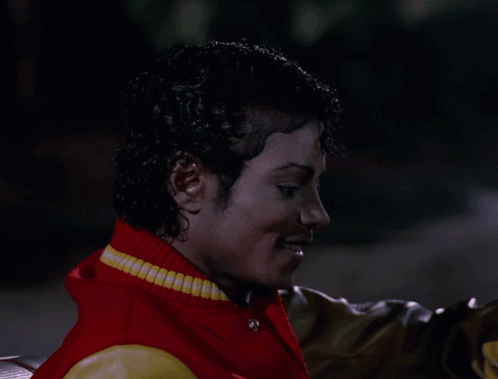 Man Red Yellow Varsity Jacket Looking At Camera GIF