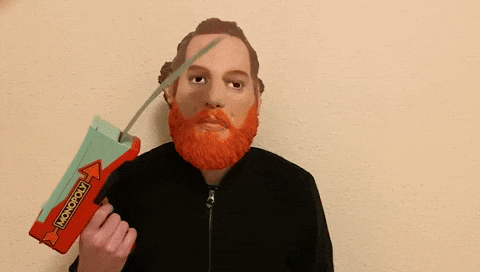 Man Releasing Monopoly Money Through Gun GIF