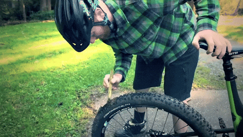 Man Removing Dog Poop From Bicycle Tire GIF