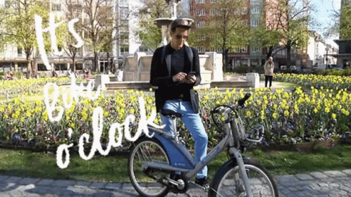 Man Riding Bike in Park Saying Its Time O Clock