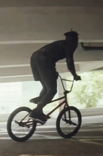 Man Riding Bike In Parking Garage GIF