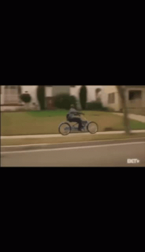 Man Riding Blue Bicycle