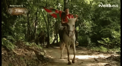 Man Riding Donkey Holding eitb.eus Flag