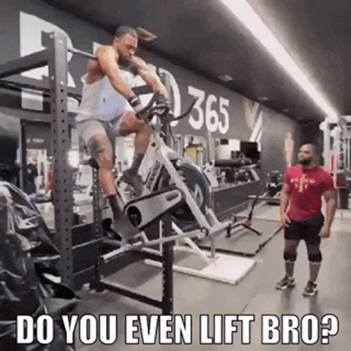 Man Riding Exercise Bike in Gym While Man Watches