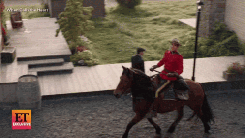Man Riding Horse in Front of When Calls the Heart Sign