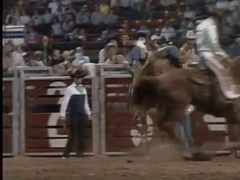 Man Riding Horse In Rodeo With Man Behind GIF