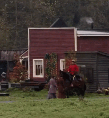 Man Riding Horse In Town GIF