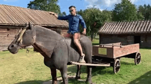 Man Riding Horse Statue Pulling Cart