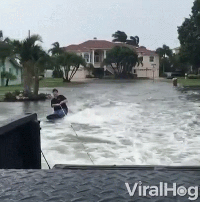 Man Riding Jet Ski In Flood GIF
