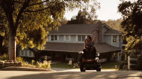 Man Riding Lawn Mower Down Driveway GIF