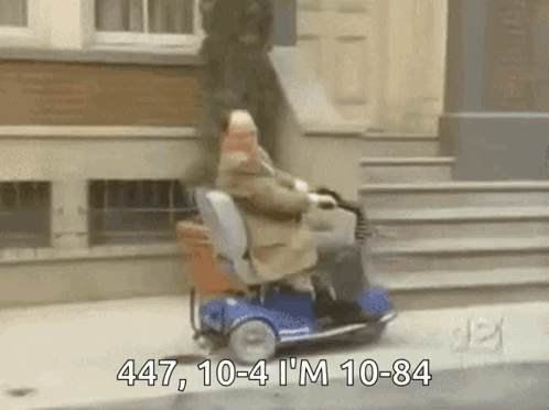 Man Riding Mobility Scooter 447 10-4 10-84