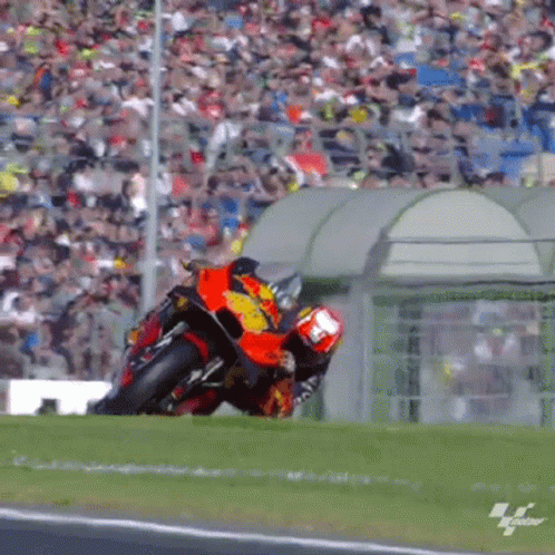 Man Riding Motorcycle on Track With Crowd