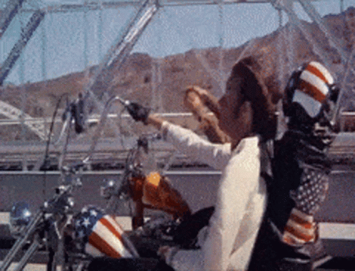 Man Riding Motorcycle With American Flag