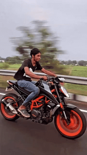 Man Riding Motorcycle with KTM Shirt