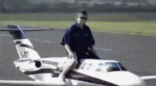 Man Riding On Back Of Small Airplane GIF