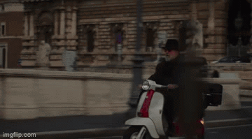 Man Riding Red and White Scooter