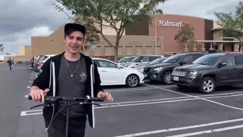 Man Riding Scooter In Front Of Walmart GIF