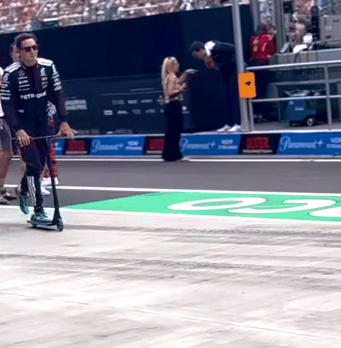 Man Riding Scooter on Race Track Number 23
