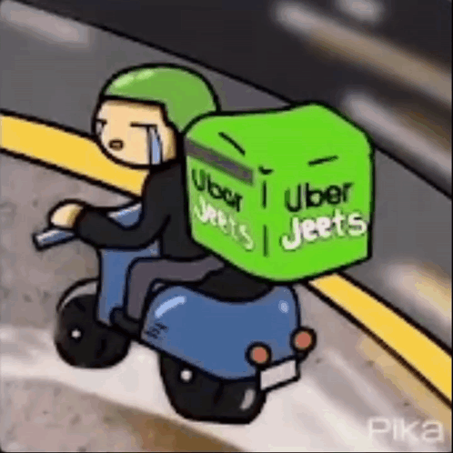 Man Riding Scooter With Green Box