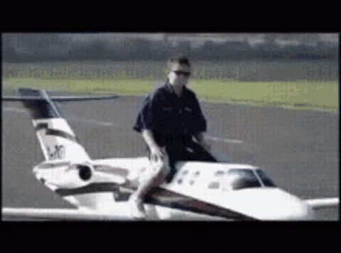 Man Riding Small Airplane LK