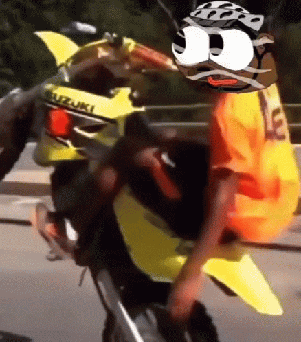 Man Riding Yellow Suzuki Motorcycle With Cartoon Face