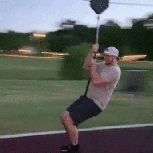 Man Riding Zip Line In Park GIF
