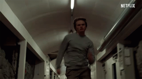 Man Running Down Hallway With Netflix Logo GIF