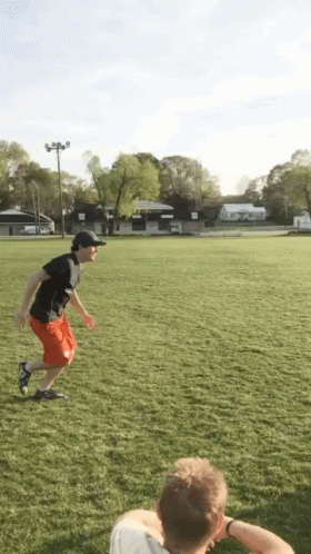Man Running in Black Shirt and Red Shorts