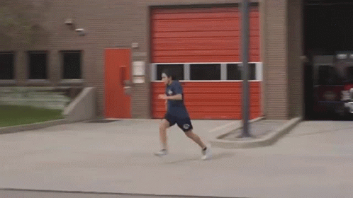 Man Running in Front of Red Door