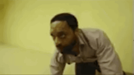 Man Running in Hallway With Picture of Man and Letter T