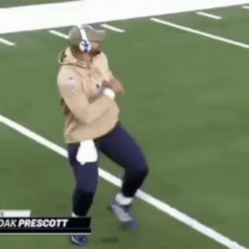 Man Running On Football Field With Headphones And Helmet GIF