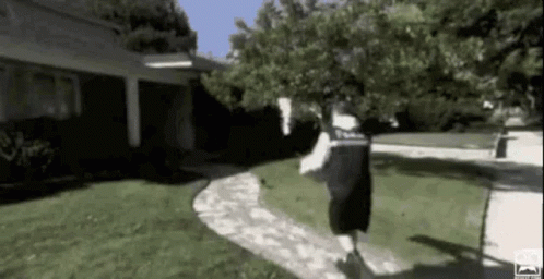 Man Running On Sidewalk Past House GIF