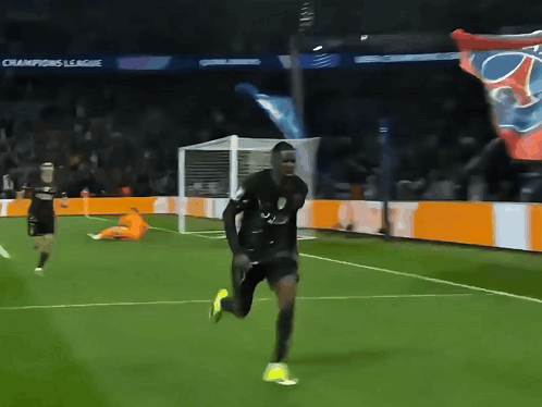 Man Running On Soccer Field With Champions League Banners GIF