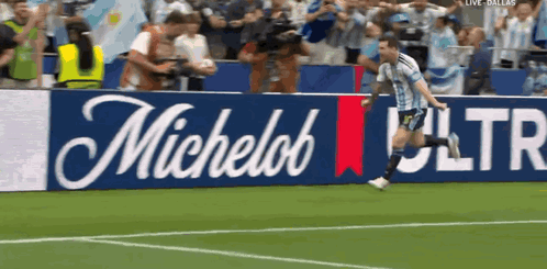 Man Running on Soccer Field with Michelob Ultra Banner