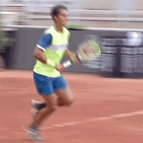 Man Running Tennis Racquet in Yellow and Blue