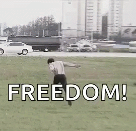 Man Running Through Grass Field With Freedom