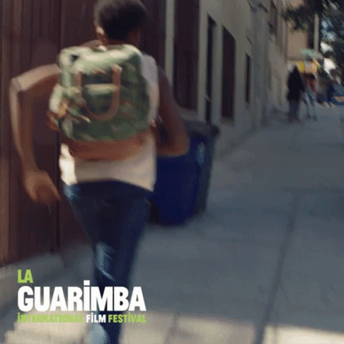 Man Running With Backpack At La Guarimba Film Festival GIF