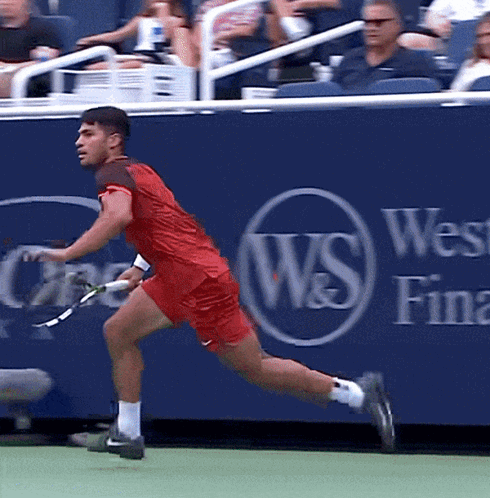 Man Running With Tennis Racquet By Blue Wall Saying W & S GIF
