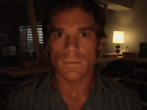 Man's Face in Dark Room With Lamp