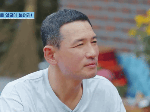 Man's Face With Blue Sign Saying Korean