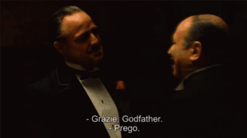Man Saying Grazie Godfather to Tuxedo Man