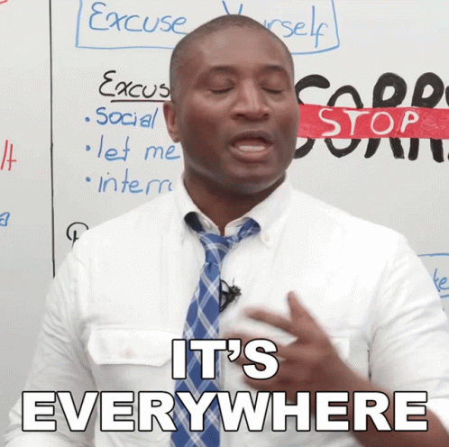 Man Saying It's Everywhere in Front of Whiteboard
