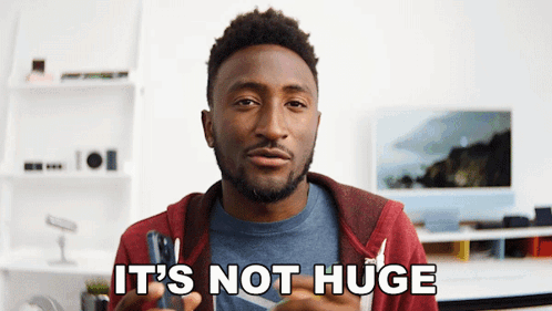Man Saying Not Huge in Front of Monitor