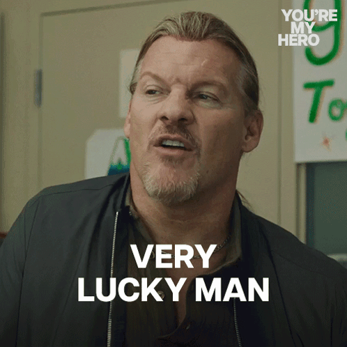 Man Saying Very Lucky Man in Front of You're My Hero Sign