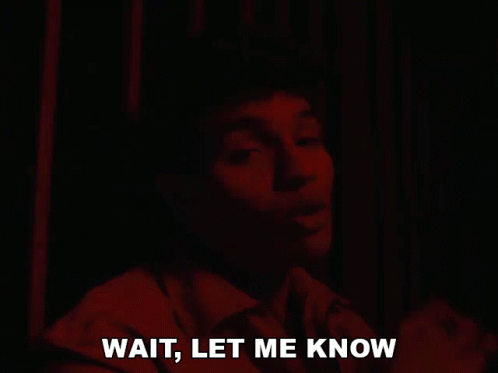 Man Saying Wait in Dark Room