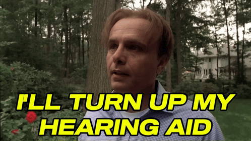 Man Says I'll Turn Up My Hearing Aid In Front Of Tree GIF