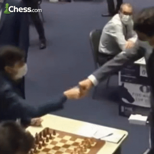 Man Shaking Hands in Front of Chessboard